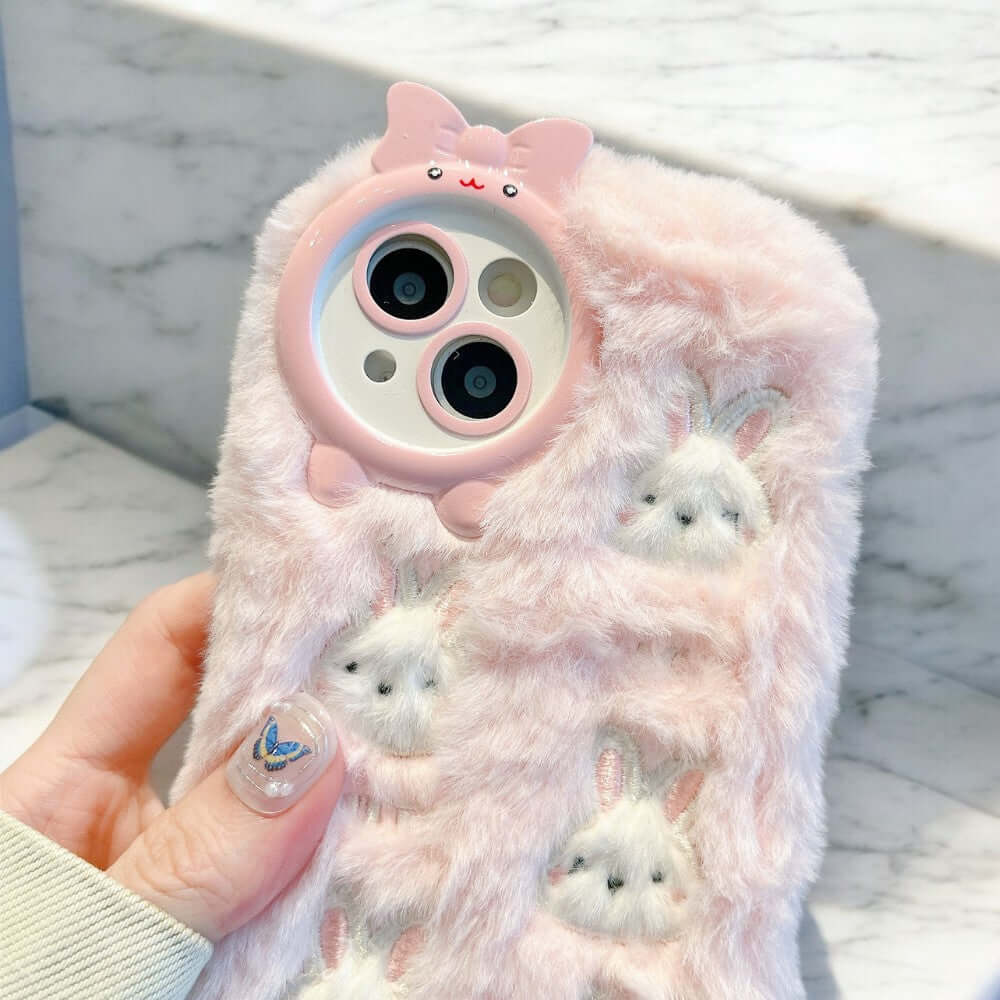 a person holding a cell phone case with cats on it