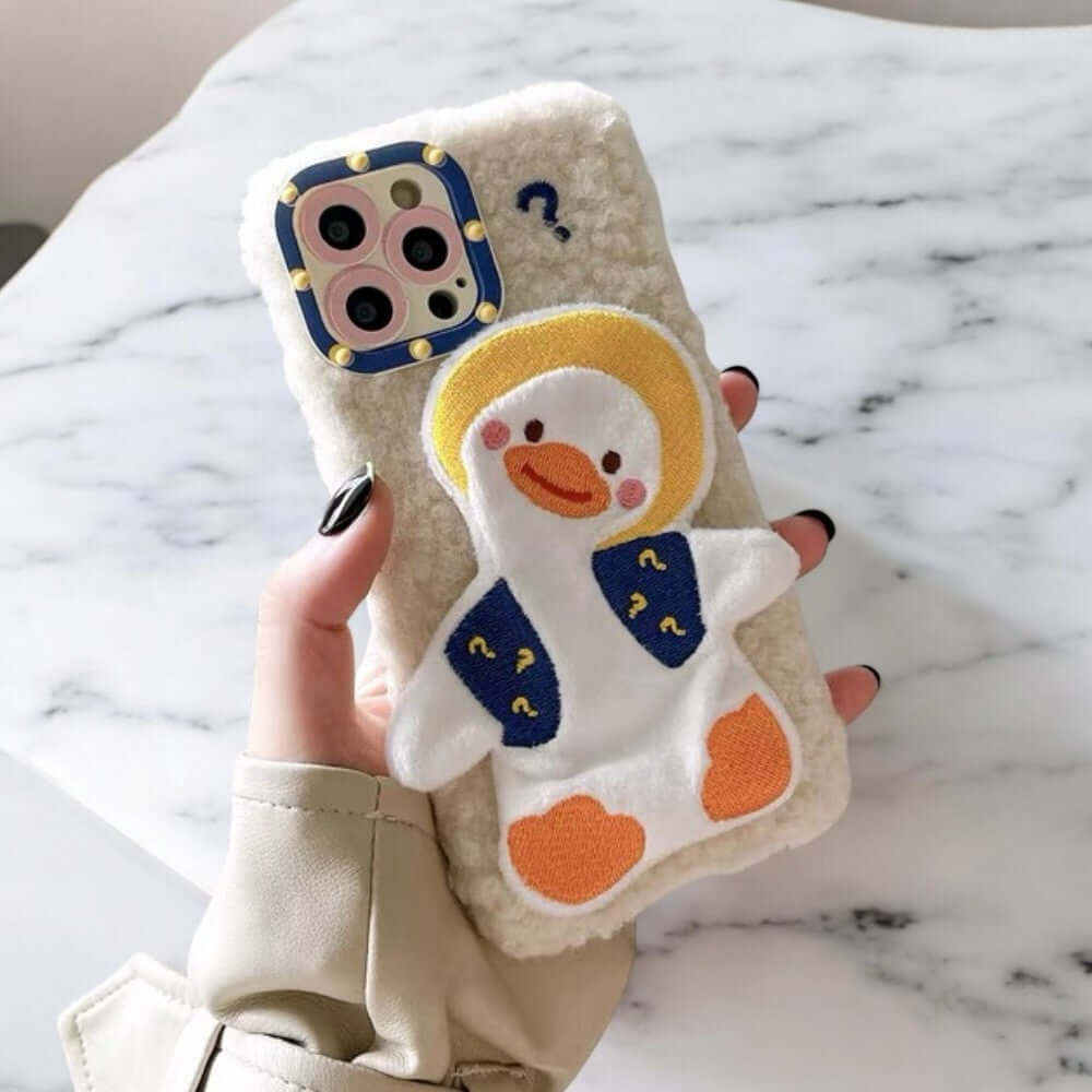 a person holding a phone case with a penguin on it