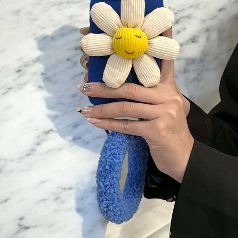 a woman holding a cell phone with a flower on it