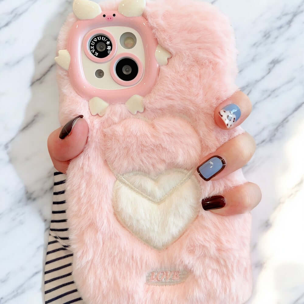 a person holding a pink phone case with a heart on it