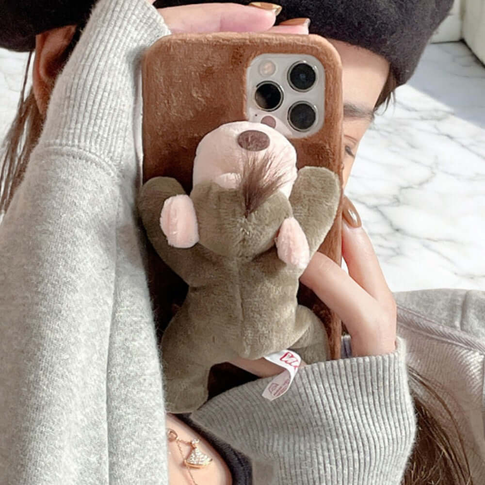 a woman taking a picture of herself holding a teddy bear