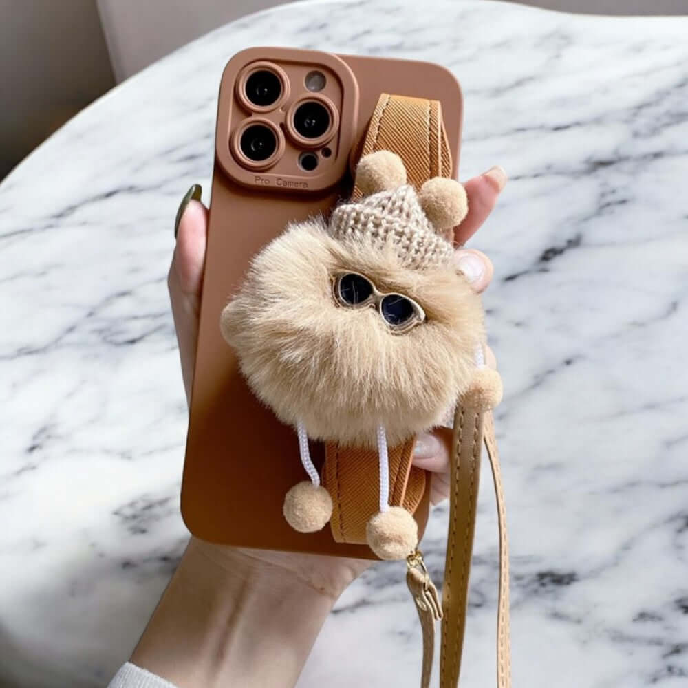 a person holding a phone case with a stuffed animal on it