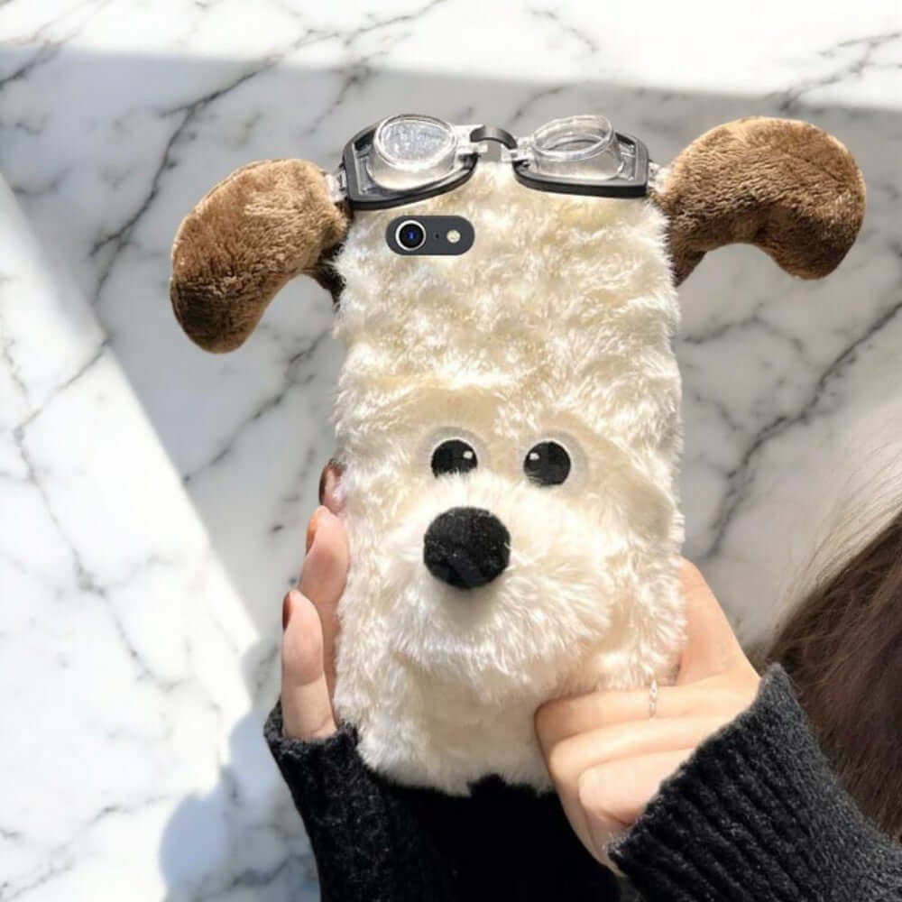 a person holding a stuffed dog with glasses on it's face