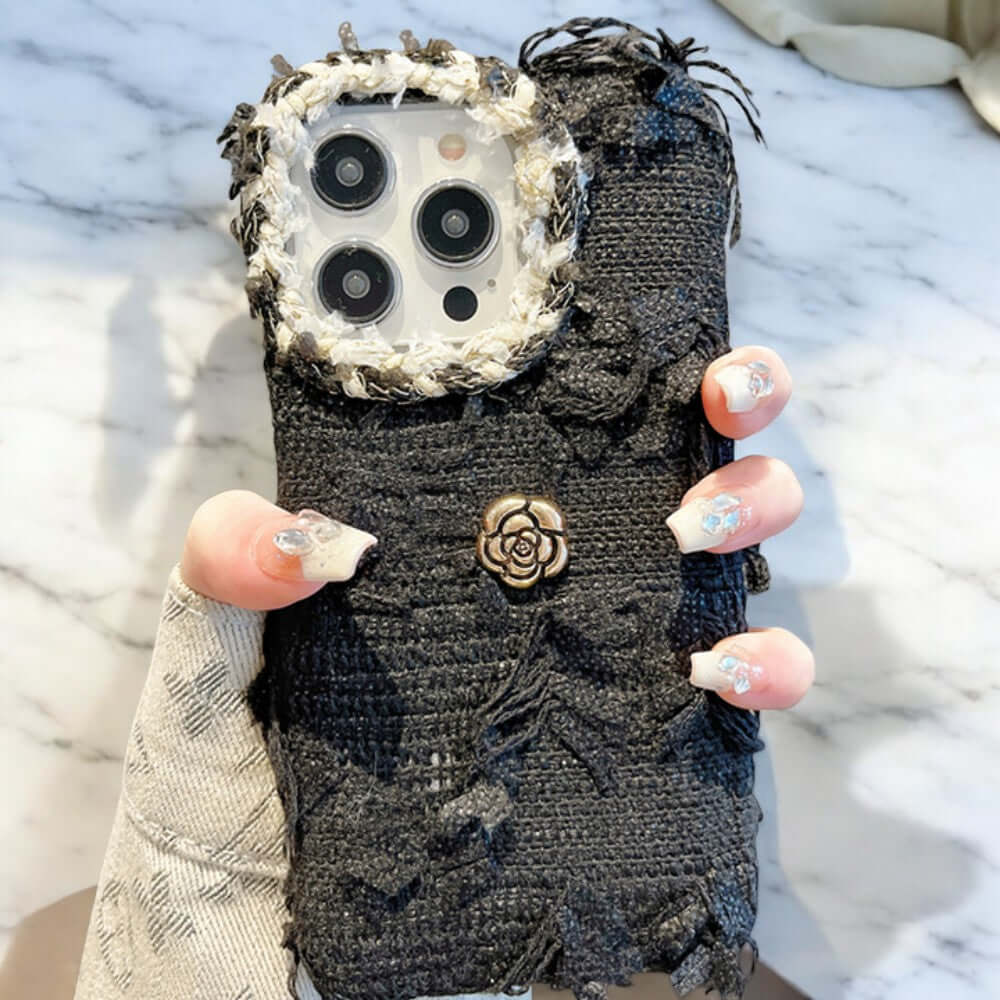 a woman holding a cell phone case with buttons on it