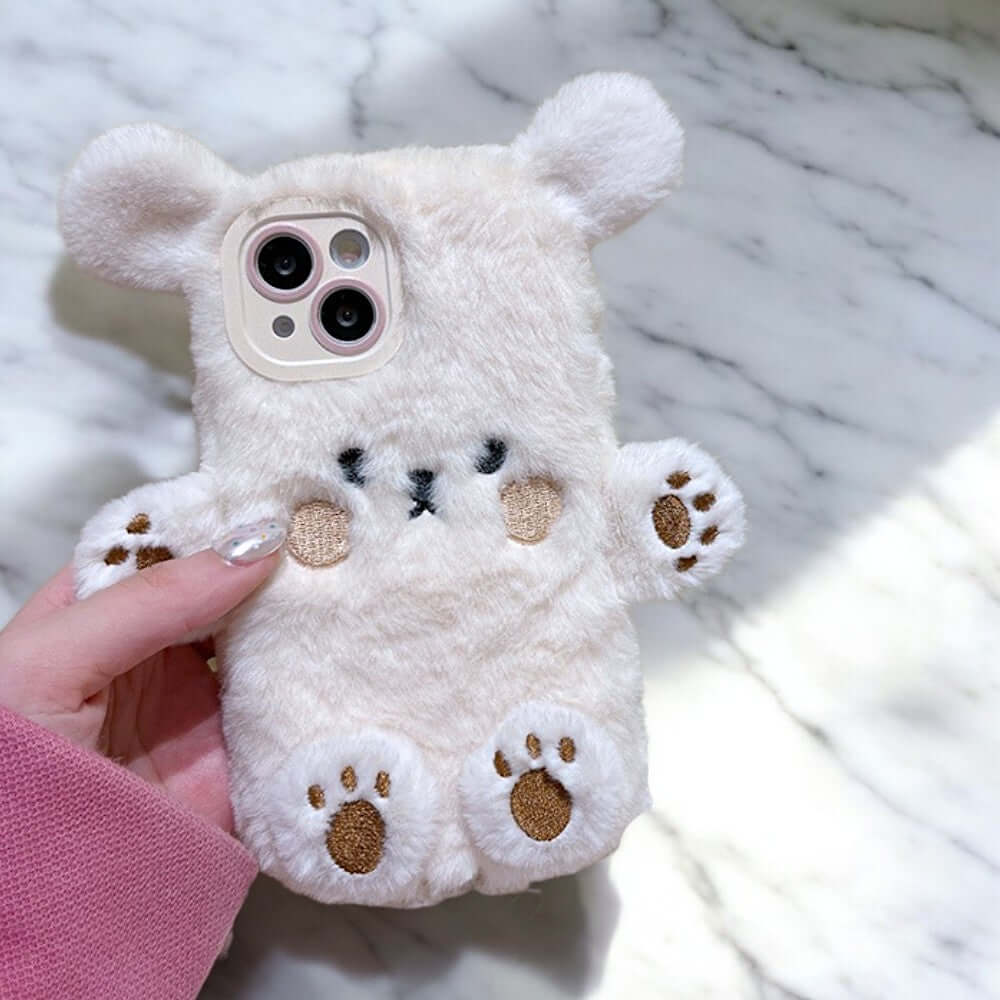 a person holding a white teddy bear phone case